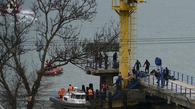 Russian rescue workers collect wreckage from the crashed plane at a pier just outside Sochi, Russia. Russian ships, helicopters and drones are searching for bodies after a plane carrying 93 people crashed into the Black Sea. Viktor Klyushin / AP