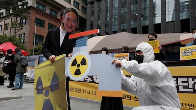An environmental activist wearing a mask of Japanese Prime Minister Yoshihide Suga performs to denounce the Japanese government's decision on Fukushima water, near the Japanese embassy in Seoul. AP