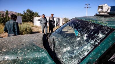 Afghan security officials inspect the scene of a suicide bomb attack that targeted an election campaign rally of incumbent president Ashraf Ghani on Tuesday. Hedayatullah Amid / EPA