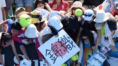 Japan's Kei Nishikori signs autographs for supporters after victory in his men's singles match against Marinko Matosevic of Australia. Mal Fairclough / AFP