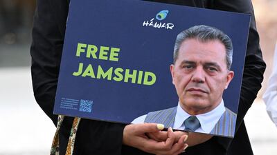 A demonstrator holds a picture of Iranian-German Jamshid Sharmahd in front of the German Foreign Ministry in Berlin on July 31. AFP