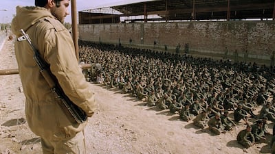 An Iranian soldier guards Iraqi prisoners of war in Ahvaz, Iran, on January 22, 1987. AFP