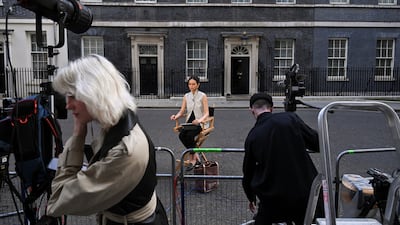 Members of the media gather outside 10 Downing Street in London. Reuters