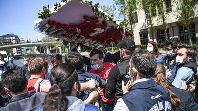 Turkish police block off May Day marchers holding a wreath near Taksim Square in Istanbul on May 1, 2020. AFP