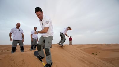 Abu Dhabi Ocean Racing team skipper Ian Walker, far left, and the Azzam crew took part in sand boarding while the shore team was at work. Courtesy ADOR
