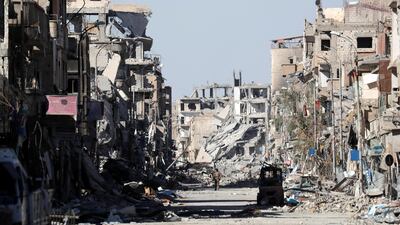 A fighter of the Syrian Democratic Forces stands amid the ruins of buildings near the Clock Square in Raqqa, Syria on October 18, 2017. Erik De Castro / Reuters