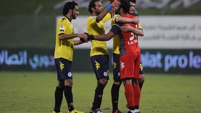 Al Dhafra players celebrate after their win over Al Nasr.