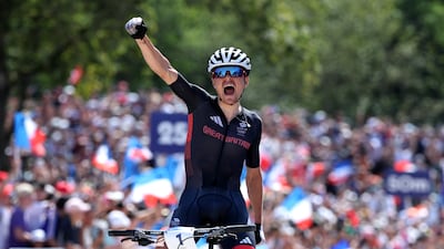 Tom Pidcock celebrates at the finish line. Getty Images