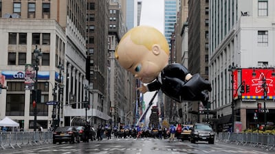 Assistants carry 'The Boss Baby' balloon during the 94th Macy's Thanksgiving Day Parade in Manhattan, New York City. Reuters