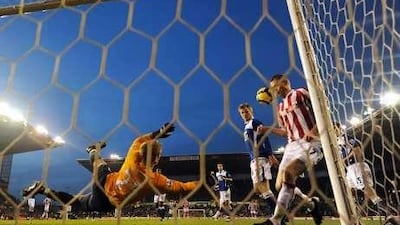 Joe Hart makes a diving save in Premier League action last season.