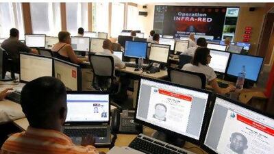 Interpol agents, like these ones above, are dealing with high numbers of financial crime fugitives who once lived in the UAE. Laurent Cipriani / AP Photo