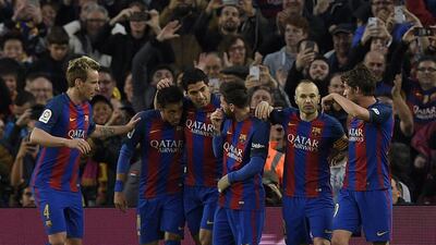Luis Suarez, centre, scored Barcelona's first goal in the 3-0 Primera Liga win against Sevilla. Lluis Gene / AFP