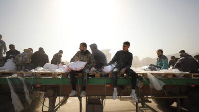 Palestinians pick up bags of flour as humanitarian aid arrives in Gaza city. AFP