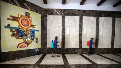 Workers sanitize the area of a residential building in Mumbai, India. EPA