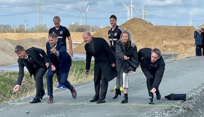 Chancellor Olaf Scholz, centre, engaged in a spot of traditional northern bowls to mark the ground-breaking ceremony in Heide. AFP