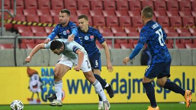 Scotland's John McGinn, left, goes down from a tackle by Slovakia's Albert Rusnak . PA