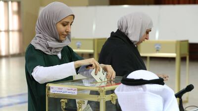 Kuwaiti women cast their votes during parliamentary elections in Kuwait City. Kuwait is holding its most inclusive elections in a decade, with some opposition groups ending a boycott after the country's royal rulers pledged not to interfere with Parliament. AFP