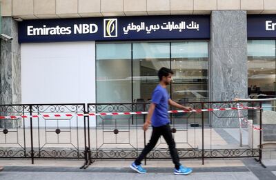The Emirates NBD branch was boarded up on Saturday after a car ploughed through the window on Thursday night. Pawan Singh / The National