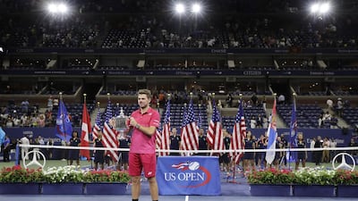 Stan Wawrinka holds up the championship trophy after beating Novak Djokovic. Darron Cummings / AP Photo