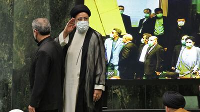 Iran's newly elected President Ebrahim Raisi waves as he arrives for his swearing in ceremony at the Iranian parliament in the capital Tehran.