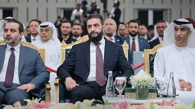 Syrian President Ahmad Al Sharaa, centre, with UAE Minister of State for Foreign Trade Thani Al Zeyoudi on Tuesday at the Syrian-Emirati Investment Forum in Damascus. Sana