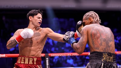 Ryan Garcia throws a right hand at Conor Benn. AFP