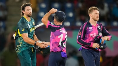 Australia's Tim David, left, is congratulated by Scotland's Chris Greaves following the T20 World Cup match at Darren Sammy National Cricket Stadium, Gros Islet, St Lucia, on Saturday, June 15, 2024. AP