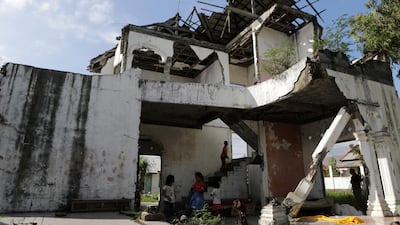 Kids play inside a house that was damaged by the 2004 Indian Ocean earthquake and tsunami, in Banda Aceh, Indonesia. EPA