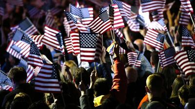 Supporters of Democratic presidential nominee Hillary Clinton wave flags during election night at the Jacob K. Javits Convention Center in New York. Kena Betancur / AFP