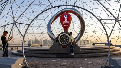 Visitors take photographs alongside Fifa World Cup countdown installation. Bloomberg