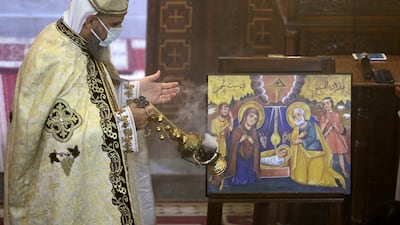 Bishop Dawod Makram leads Midnight Mass at the Church of St George. Face masks are obligatory and social distancing is diligently observed. AP Photo