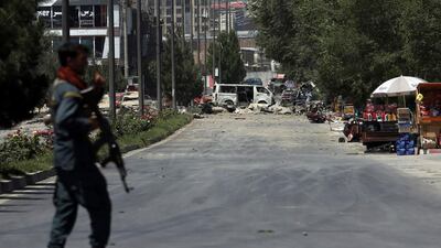 A security forces soldier arrives at the site of an explosion in Kabul, Afghanistan, Monday, July 1, 2019. A powerful bomb blast rocked the Afghan capital early Monday, rattling windows, sending smoke billowing from Kabul's downtown area and wounding dozens of people, including nine children hurt by flying glass, officials and a medic said. (AP Photo/Rahmat Gul)
