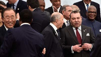 French Minister Of Foreign Affairs Laurent Fabius speaks with King Mohamed VI at COP21 in Paris in November 2015. Getty Images