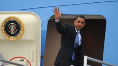 The US president Barack Obama waves as he boards Air Force One.