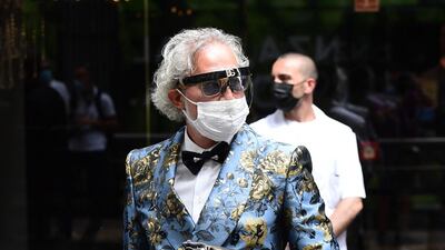 A guest arrives at the Dolce & Gabbana show during Milan Men's Fashion Week on June 19, 2021 in Milan, Italy. AFP