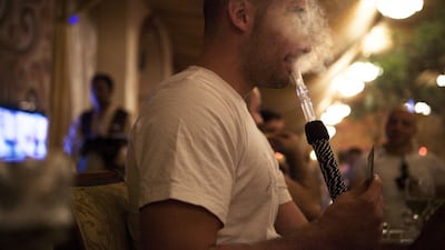 Smoking shisha with family and friends is a way of life that doesn't need to hurt children. Lee Hoagland / The National