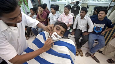 Ajman, August 8, 2011 - Lincoln Shil moved from Bangladesh four months ago. Now he works as a barber in the Al Rehab Hair Cutting Saloon in the Al Nakeel neighborhood near the Gold Souk in Ajman City. (Jeff Topping/The National)