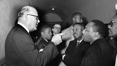 In this March 1, 1965 photo, Registrar Carl Golson shakes a finger at Martin Luther King Jr, during a meeting at the courthouse in Hayneyville, Alabama. King inquired about voter registration procedures but Golson told him that if he was not a prospective voter in Lowndes county, "it's none of your business." King visited two nearby counties after leading a voter registration drive in Selma. Harry Cabluck / AP Photo