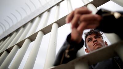 A migrant waits at the bridge. Reuters