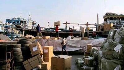 Boatmen load Iran-bound ships with goods at Dubai's creek in 2010. Reuters