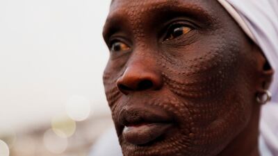 A worshipper waits for the Pope to lead mass. Reuters