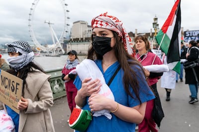 Health workers in London march from St Thomas' Hospital to Downing Street demanding a ceasefire in Gaza. Alamy