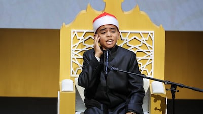 A young participant recites a verse from the holy Quran at the Arab Reading Challenge ceremony
