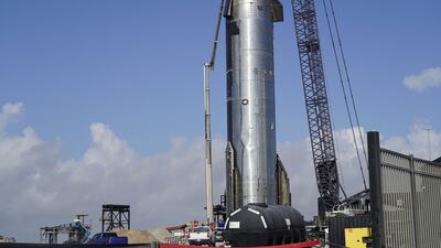 Workers prepare to move a Starship rocket.