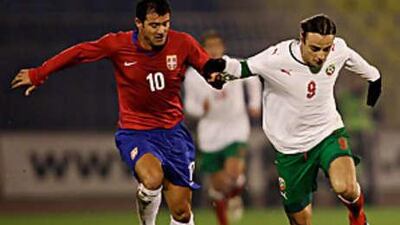 Dimitar Berbatov, in white, in action for Bulgaria where he later sustained a hamstring injury in the 6-1 defeat to Serbia.