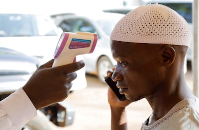 A medical officer checks the temperature of a man to screen against the spread of Ebola virus at the Platinum Medical Centre in Kampala, Uganda on May 26. Reuters