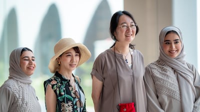 Alia Aleissaee, far left, and Ms Al Ansaari, far right, with visitors at the pavilion. Photo: UAE Pavilion Expo 2025 Osaka