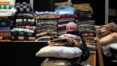 A Ukrainian refugee with pillows and blankets at a centre in Nadarzyn, near Warsaw, Poland. AP
