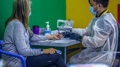 A blood pressure check before receiving the coronavirus vaccine in Abu Dhabi. Photo: Abu Dhabi Department of Education and Knowledge