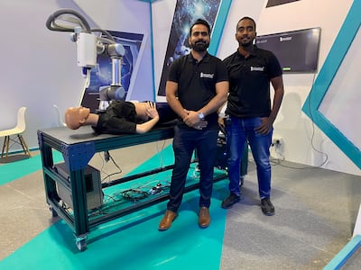 Mohamed Osama El Nour and Abdul Wahid Ansari, who work as AI specialists and software engineers for Maria Medical Technology, show off their iLaser invention at Gitex. Photo: Georgia Tolley / The National